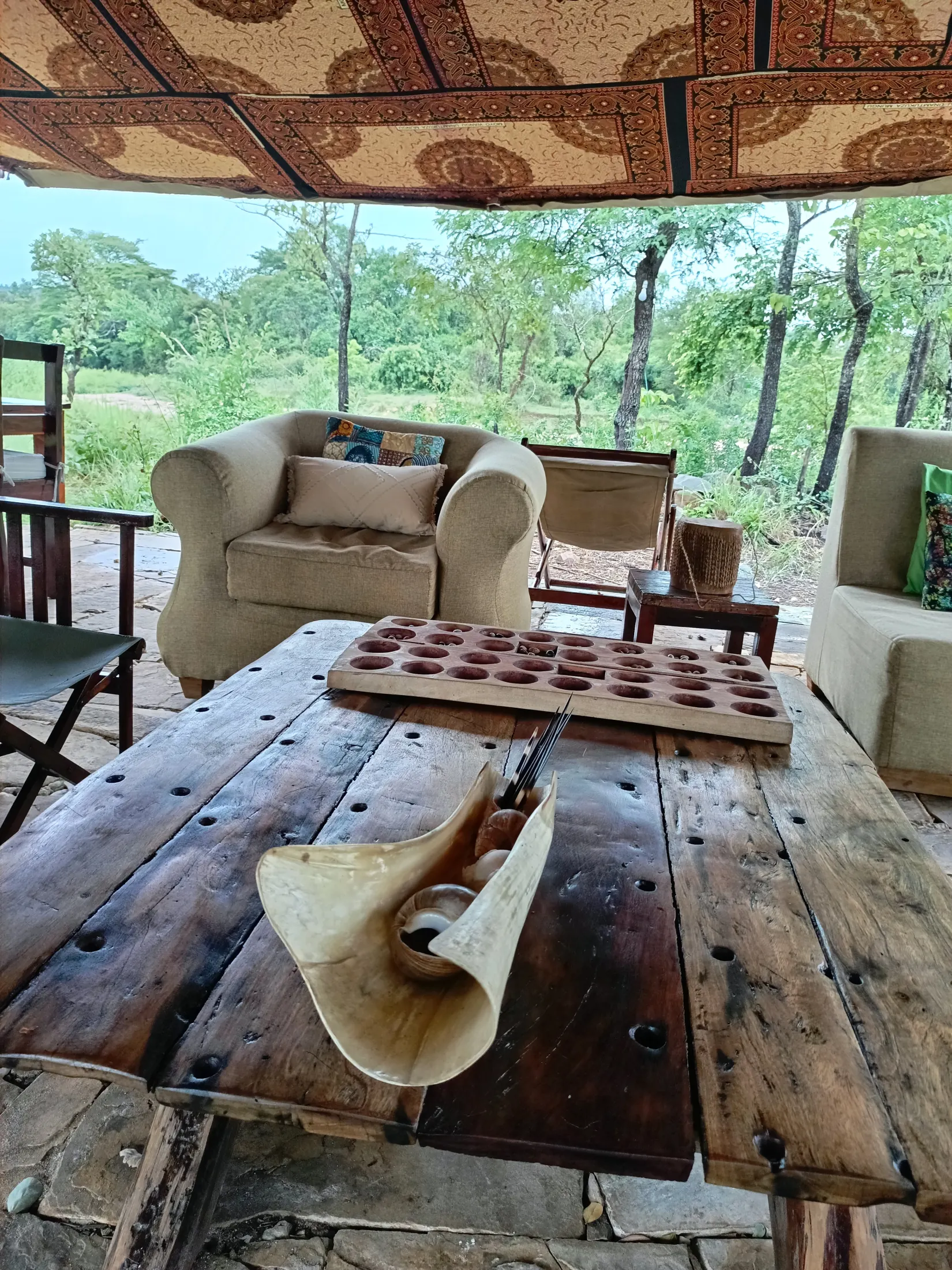 Nje Bush Camp lounge with armchairs overlooking the wilderness